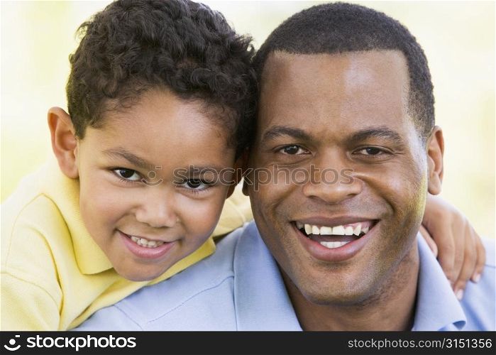 Man and young boy outdoors smiling