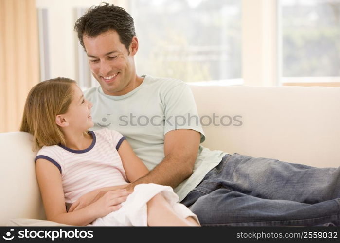 Man and young girl in living room smiling