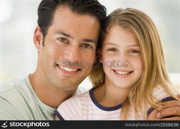 Man and young girl in living room smiling