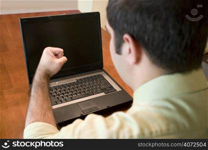 Man angry at a laptop