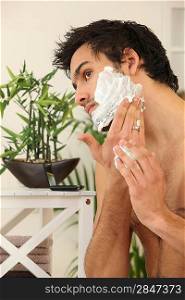 Man applying shaving foam
