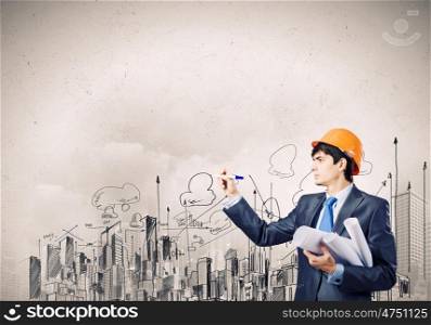 Man architect. Young man engineer drawing sketches of construction project