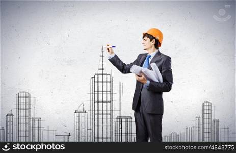 Man architect. Young man engineer drawing sketches of construction project