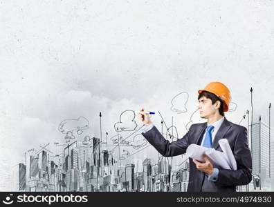 Man architect. Young man engineer drawing sketches of construction project