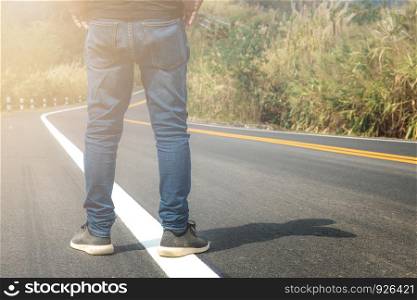 Man are standing on street in countryside with sunlight.