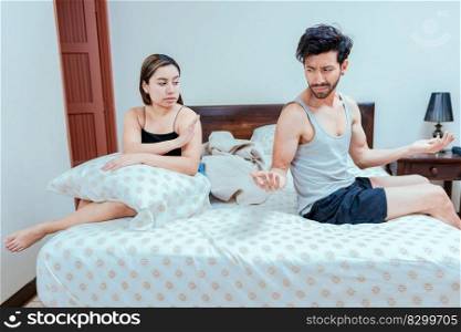 Man arguing with his wife in the bedroom bed. Upset wife ignoring husband in bed. young couple arguing in the bedroom. Concept of couple crisis in bed