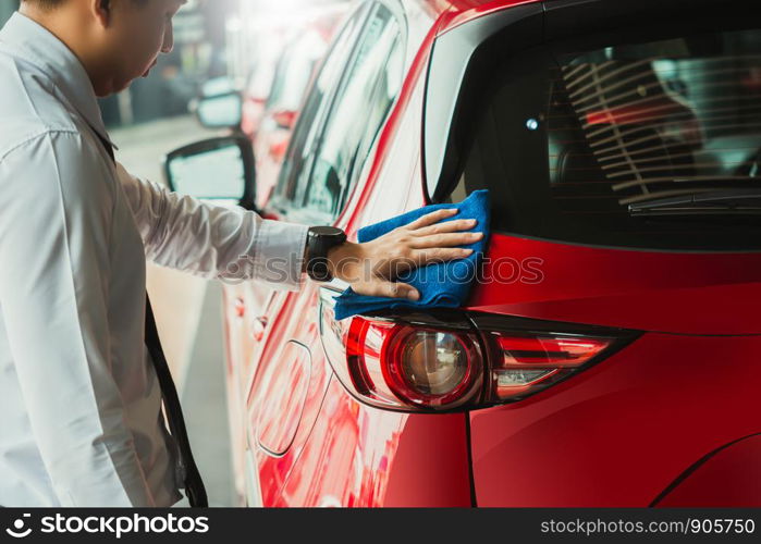 Man asian inspection headlamp and cleaning Equipment car wash With red car For cleaning to quality to customer on car showroom of service transport automobile transportation automotive image.