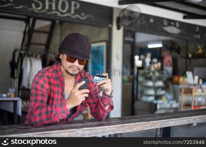 Man asian using phone and credit card shopping online