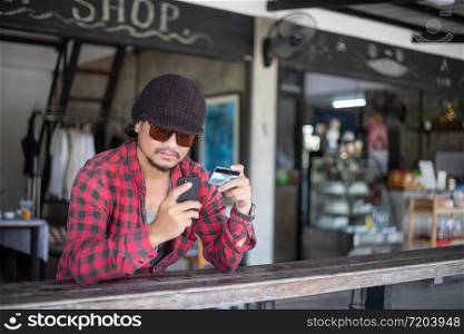Man asian using phone and credit card shopping online