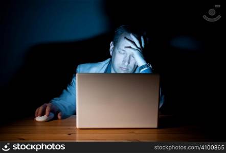 Man asleep in front of his computer