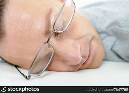 Man asleep wearing spectacles