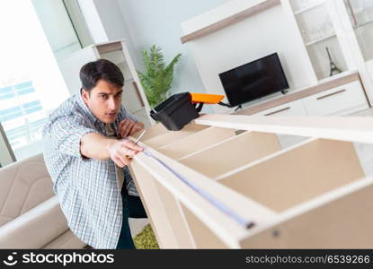 Man assembling furniture at home