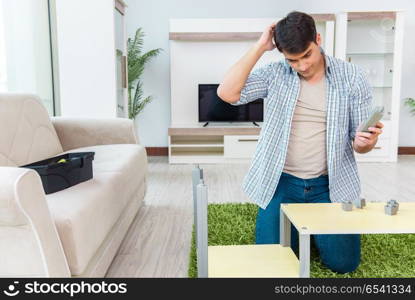 Man assembling furniture at home