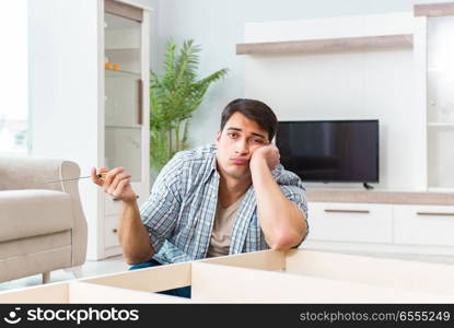 Man assembling furniture at home