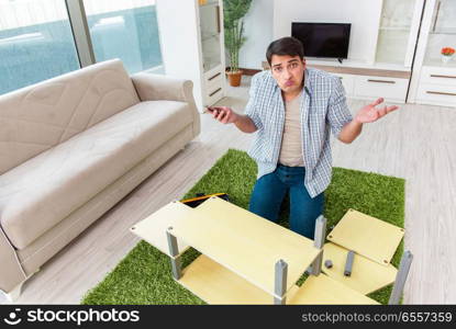 Man assembling furniture at home