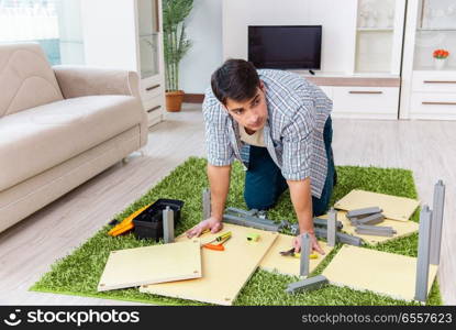 Man assembling furniture at home