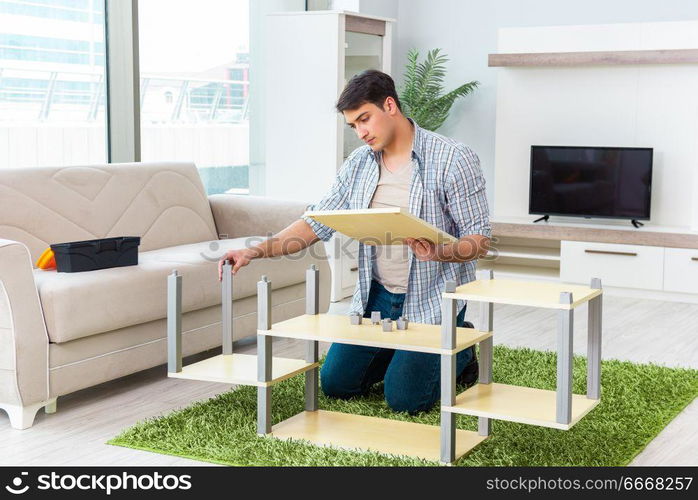 Man assembling furniture at home