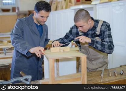 man assembling shelf at workshop