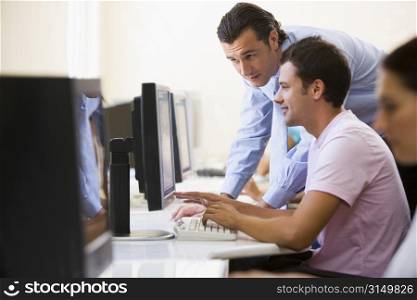 Man assisting other man in computer room