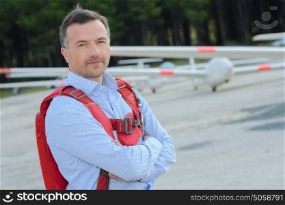 Man at airfield wearing backpack