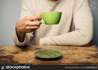 Man at desk with a cup of coffee