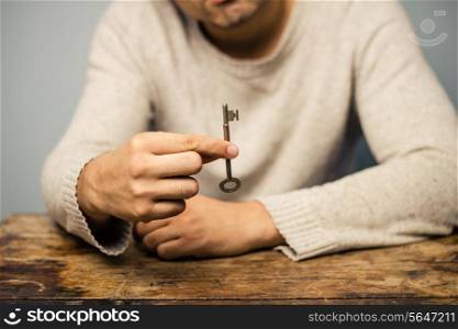 Man at desk with a key