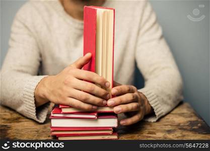 Man at desk with books