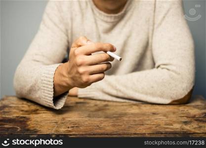Man at desk with cigarette