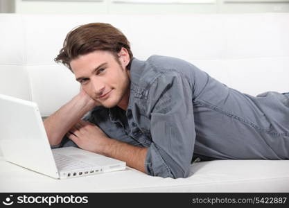 Man at home using laptop computer