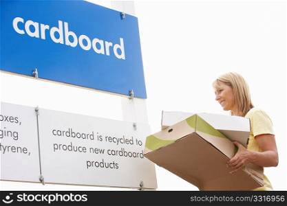 Man At Recycling Centre Disposing Of Cardboard
