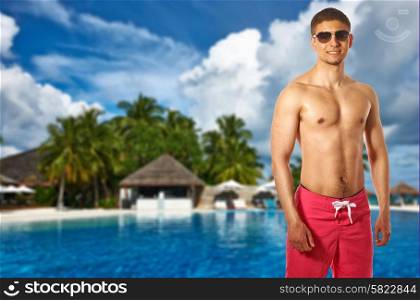 Man at swimming pool in the tropical hotel. Collage.