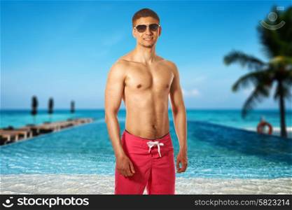 Man at swimming pool in the tropical hotel. Collage.