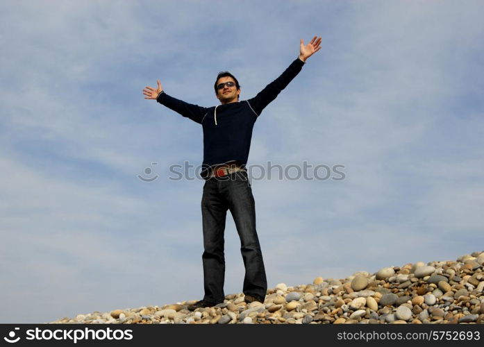 man at the beach dunes with arms open