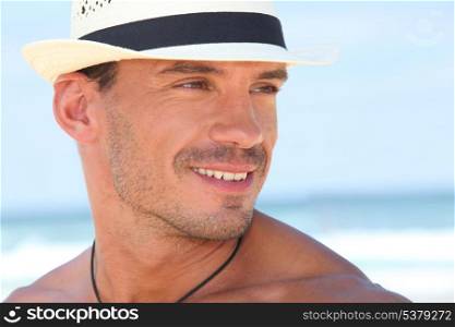 Man at the beach wearing hat