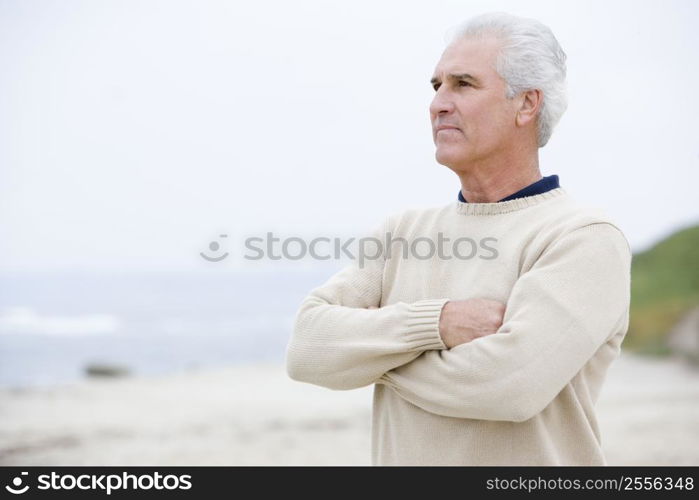 Man at the beach with arms crossed