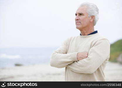 Man at the beach with arms crossed