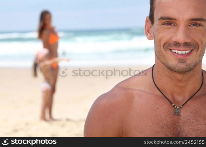 Man at the beach with his family