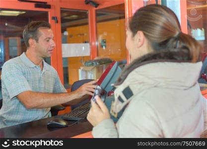 man at the cashiers desk
