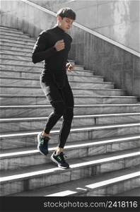 man athletic wear working out stairs outdoors