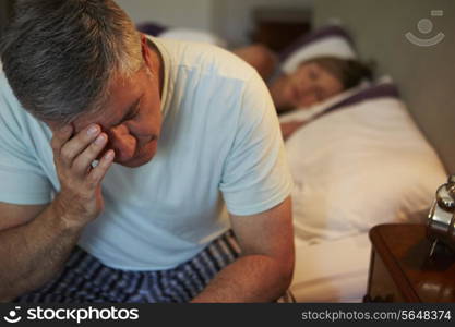 Man Awake In Bed Suffering With Insomnia