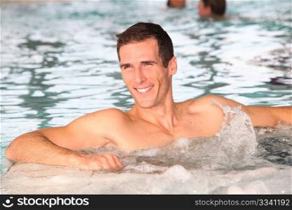 Man bathing in jacuzzi of spa center