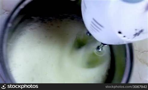 man begins with help of modern mixer to blend egg white timelapse