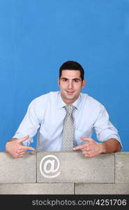 Man behind wall with email symbol