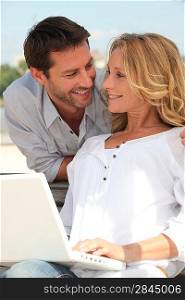 Man behind woman with computer
