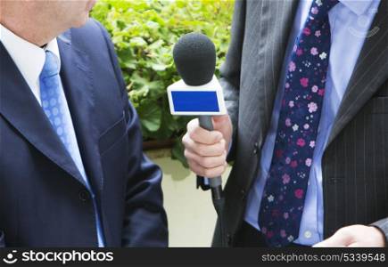 Man Being Interviewed By Journalist For TV Or Radio