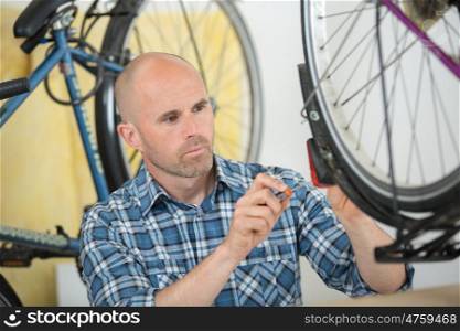 man bicycle mechanic repairing bicycles