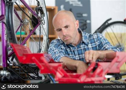 man bicycle mechanic repairing bicycles