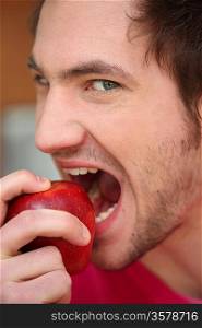 Man biting into a red apple