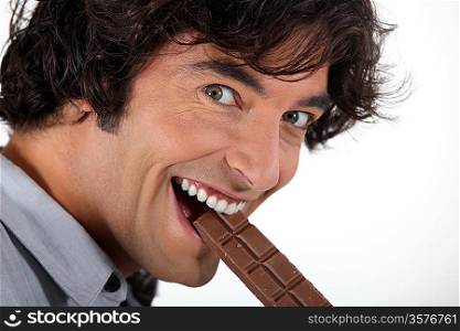 Man biting into chocolate bar