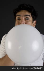 Man blowing air into a balloon